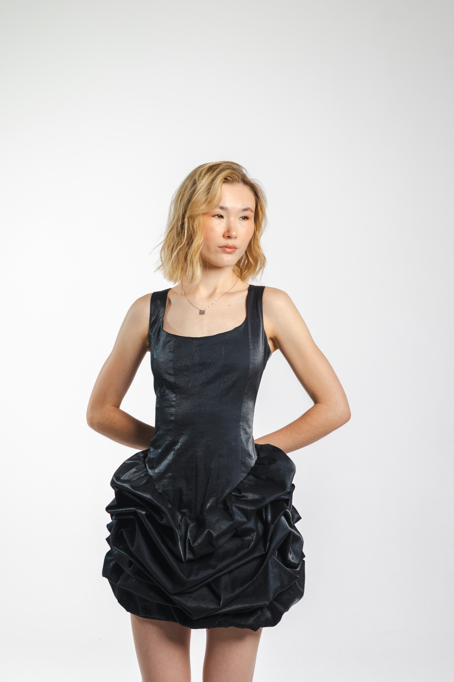 Luna Dress – black cotton satin dress with fitted waist-accentuating top and flared draped skirt, front view